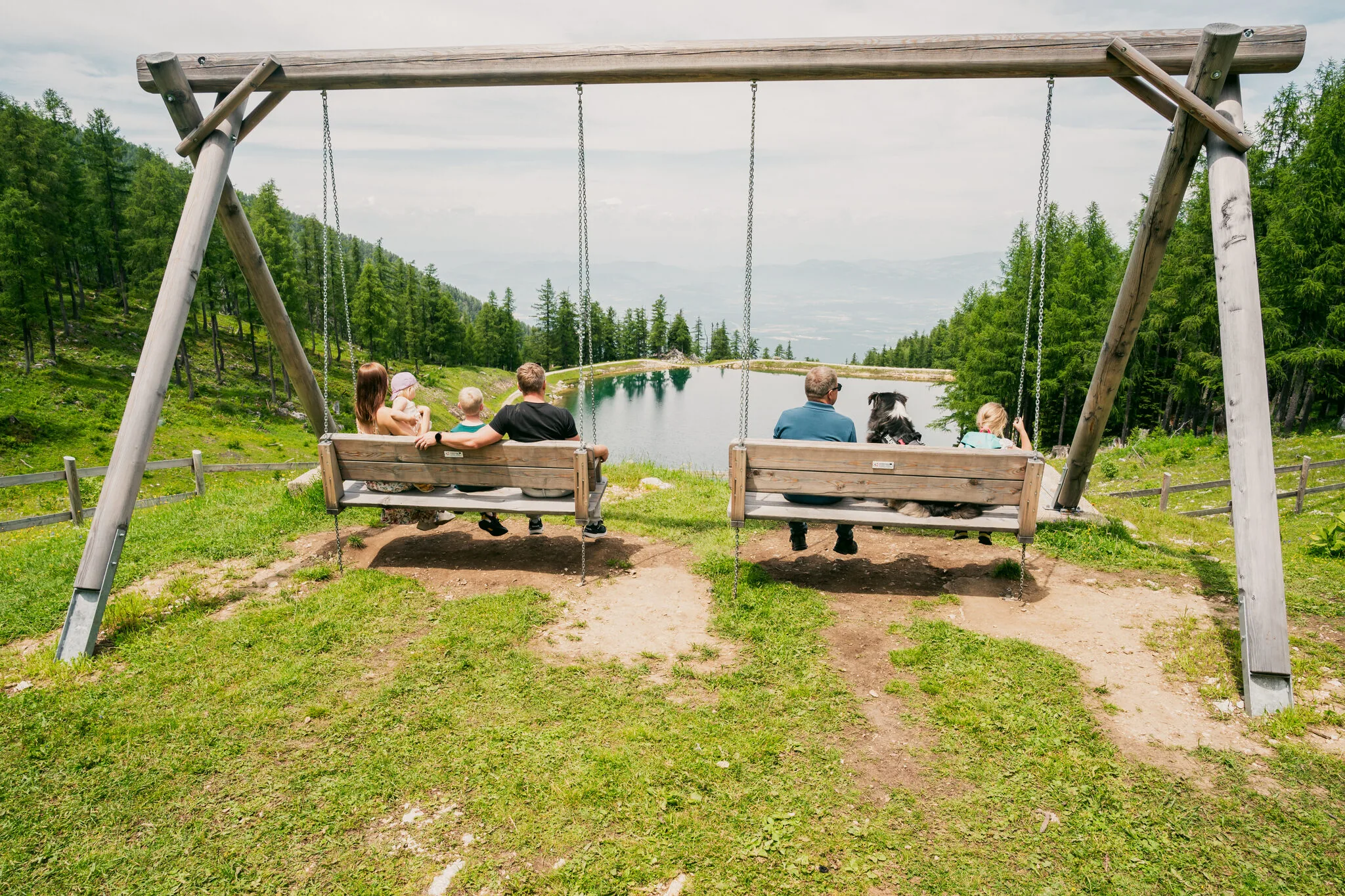 Panorama swings by the Petzen mountain lake