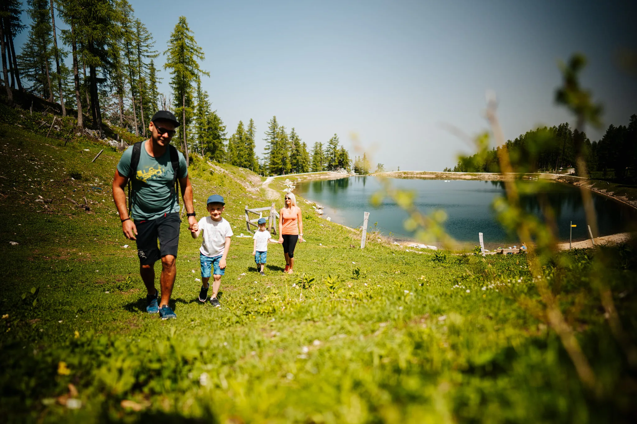 Family hiking by the mountain lake on the Petzen